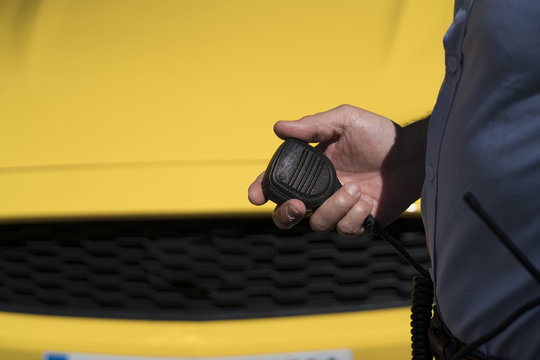 Crop policeman with portable radio set outside