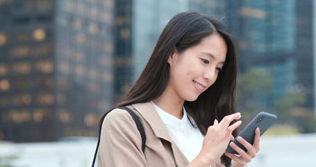 Business woman look at mobile phone