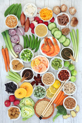 Macrobiotic food concept with seafood, miso paste, tofu, kuchika tea, wasabi nuts, vegetables, whole wheat pasta, legumes and grains with foods high in protein, antioxidants, vitamins and minerals.  