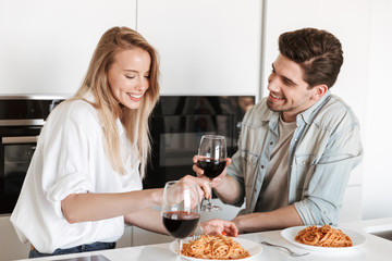 Loving couple in kitchen have a dinner