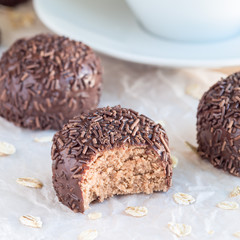 Swedish sweets Arrack balls, made from cookie crumbs, cocoa, butter and coconut wine Arrack flavour, square format, closeup