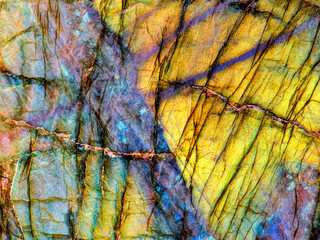 Amazing colorful texture of iridescence Labradorite Mineral gemstone background macro close-up....