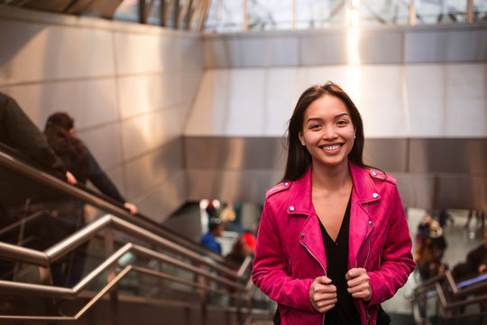 Charming young woman on stairs in subway