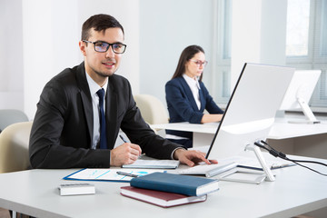 Young businessman working with computer in an office