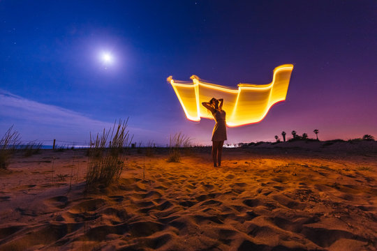 Silhouette of woman with colored lights