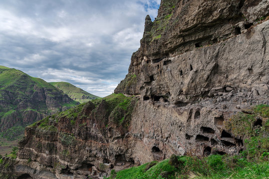 Gorgeous view from Vanis Kvabebi on a green valley in the mountains and a narrow river against cloudy sky in Samtskhe-Javakheti, Georgia