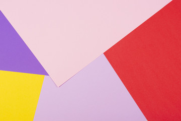 Color papers geometry flat composition background with violet, purple, pink, red, yellow tones.