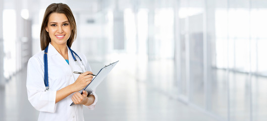 Young female doctor on modern clinic background.
