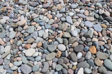 Smooth round pebbles textured background. Pebble sea beach close-up
