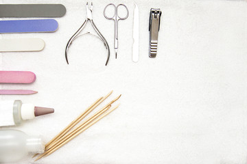 manicure tools, nail files and wooden sticks for cuticle, tweezers and scissors, as well as tools for cuticle and nail care
