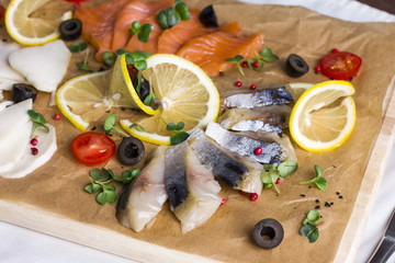 Fototapeta na wymiar Different types of fish herring, salmon on wooden Board