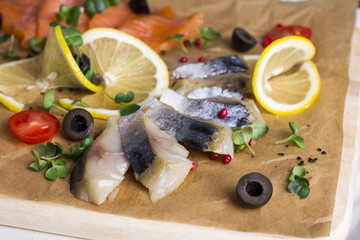 Different types of fish herring, salmon on wooden Board