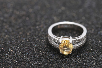 Yellow gem stone on diamond ring