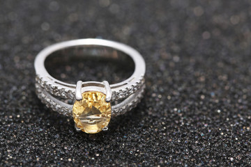 Yellow gem stone on diamond ring