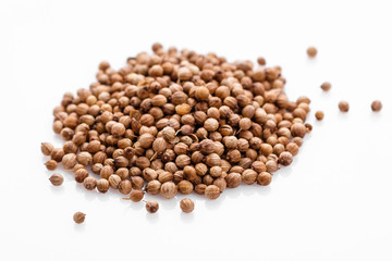 fragrant coriander seeds on a white background