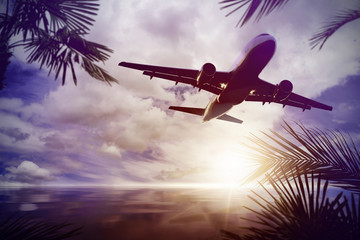 plane flying over tropical ocean