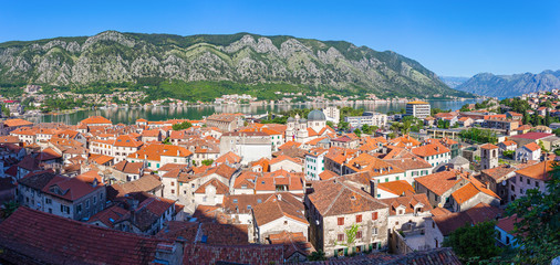 Fototapeta na wymiar Panoramic view from above on the old historical city Kotor with orange tile roofs, boka-kotor bay and mountains at Adriatic sea coastline, Montenegro