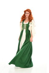 Fototapeta premium full length portrait of red haired girl wearing long green medieval gown. standing pose, isolated on white studio background.