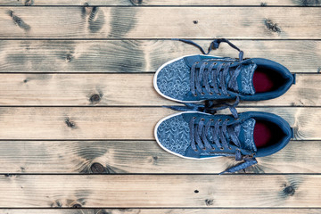 Women's sport shoes on rustic wooden background