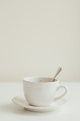 Vertical photo of cup of tea on white background. Minival food style