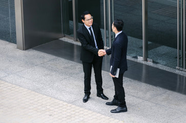 two business young asian smart man talking information about finance news together standing in...