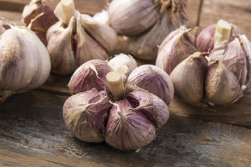 Fresh garlic on white background. Garlic cloves. Peeled garlic bulbs on jute.