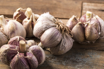 Fresh garlic on white background. Garlic cloves. Peeled garlic bulbs on jute.