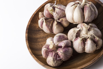 Fresh garlic on white background. Garlic cloves. Peeled garlic bulbs on jute.