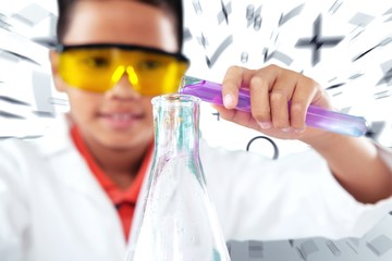 Composite image of schoolboy performing experiment