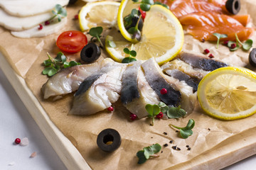Fototapeta na wymiar Different types of fish herring, salmon on wooden Board