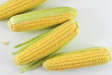 Corn on a white surface. Close-up. View from above.