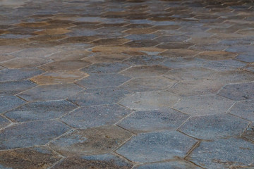 Perspective view on gray paving stones. Street floor made with hexagon shaped concrete plates