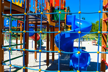 The children's playground is made in bright colors. new slides, a grid, stairs ready to please the kids
