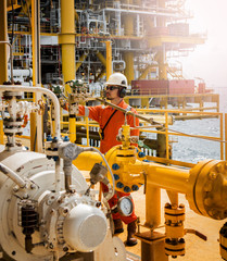 operator recording operation of oil and gas process at oil and rig plant, offshore oil and gas...