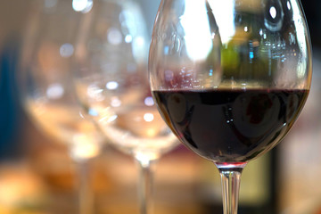 White wine pouring into glasses, close up view.