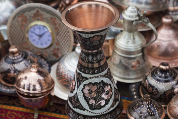 copper kitchenware on the ground. local copper materials in the shop.