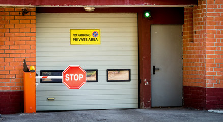 Fototapeta premium Entry to an underground car park with automatic gates and a barrier.