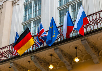 National flags of world countries on the building facade. Flags of USA, Russia, Germany, European...