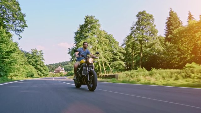 motorbike on the road riding. having fun riding the empty road on a motorcycle tour / journey 4k video