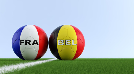 France vs. Belgium Soccer Match - Soccer balls in France and Belgium national colors on a soccer field. Copy space on the right side - 3D Rendering 