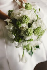 Bridal bouquet held by her with her hands at her wedding