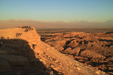 Fototapeta na wymiar Many people waiting for the beautiful sunset at the Moon Valley in Atacama Desert, San Pedro Atacama, Northern Chile 