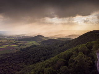 Obraz na płótnie Canvas Regenwolken im Lichte des Sonnenaufgangs - Luftaufnahme