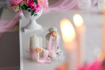Fototapeta na wymiar Beautiful decor of candles and flowers. White Pink shades.