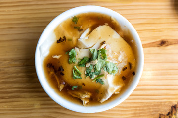 Jellied bean curd with green parsley leaves. Tofu pudding. Unique Traditional Chinese Foods