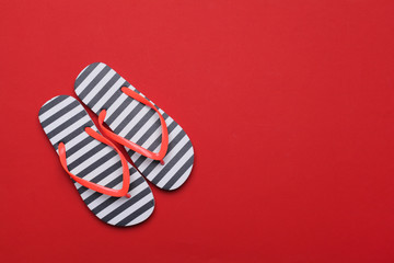 Summer beach flip flops on colored background
