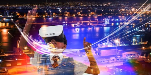 Composite image of schoolboy wearing virtual reality headset