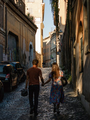 Couple walking the street in Rome, Italy. October 2017.