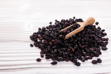 dried barberry berries on the rustic background