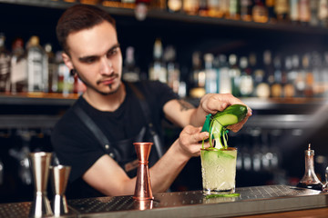 Preparing Cocktails. Bartender Making Cocktail In Bar